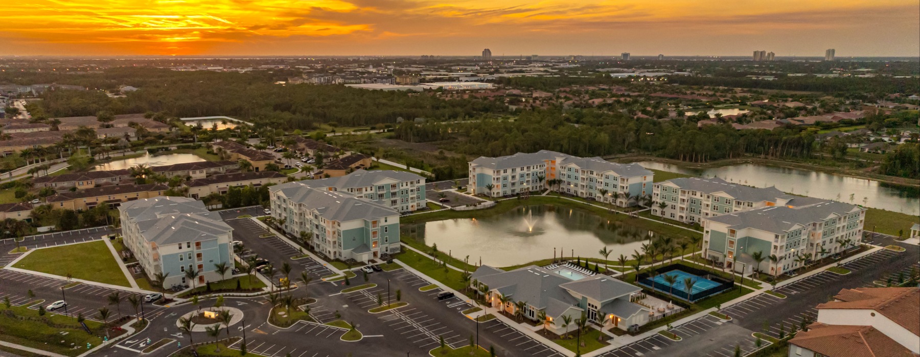aerial of community and surrounding neighborhoods at sunset
